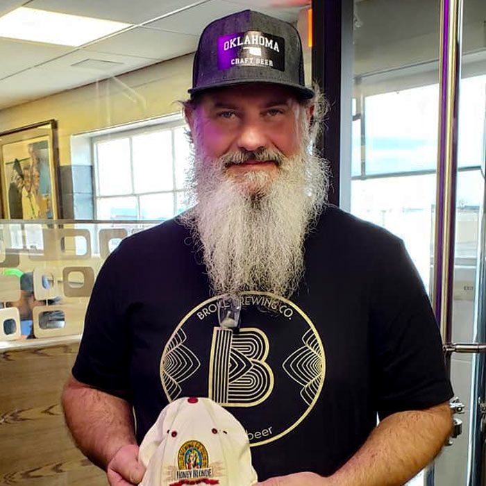 broke brewing co master brewer posting with a hat in hand