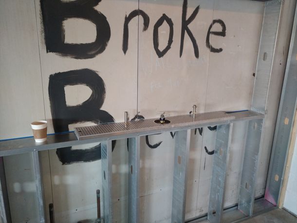 broke brewing co history photo of bar taps being installed